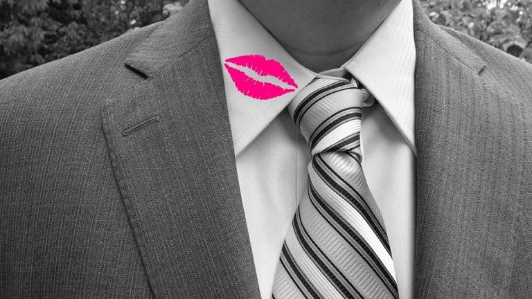close up shot of man with a tie and a kiss on his collar