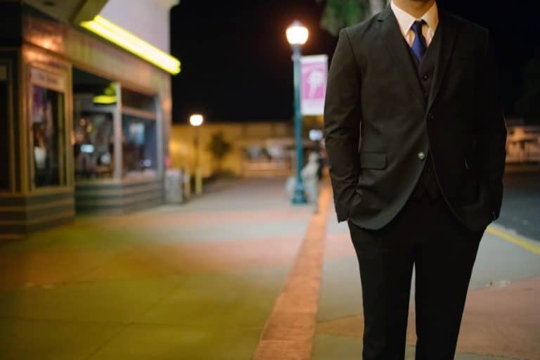 lawyer standing on street at night