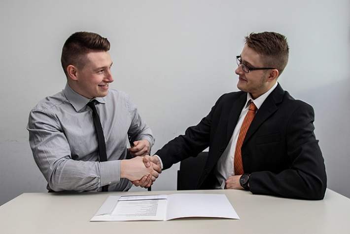 business men shaking hands after contract agreement