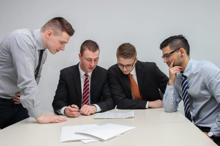 businessmen looking at documents in meeting