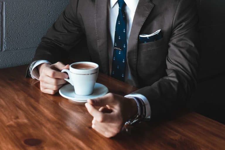 business man sitting at cafe table with a coffee