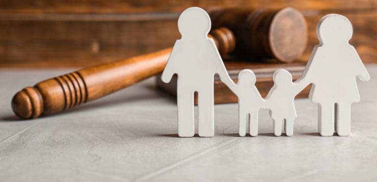 family figure and gavel on table. Family law concept