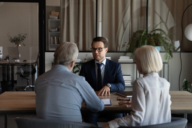 a lawyer having a meeting with mature couple clients