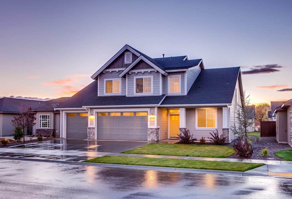A house with a garage and driveway at dusk, highlighting the Stamp Duty implications in NSW.