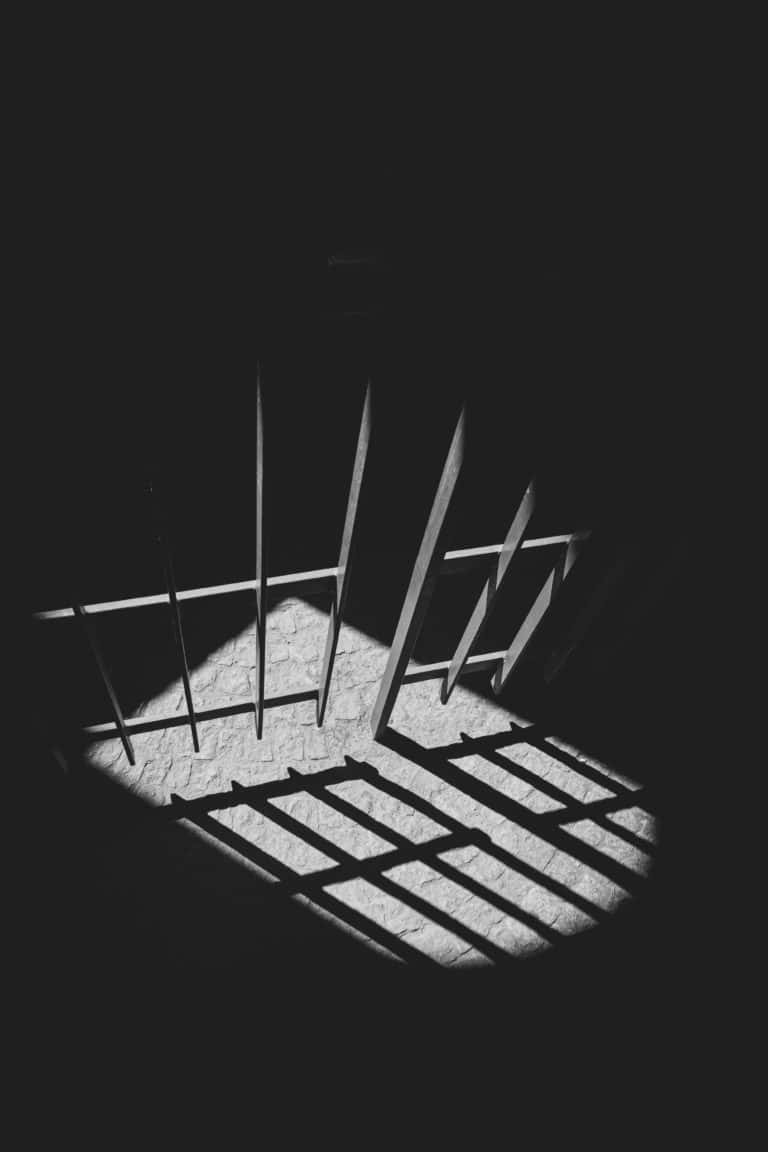 A black and white photo capturing a prison cell with no conviction recorded.