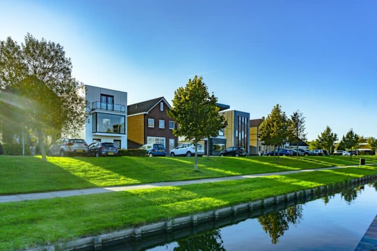 A row of houses next to a waterway located in an area with increasing interest rates and concerns about mortgage payments.
